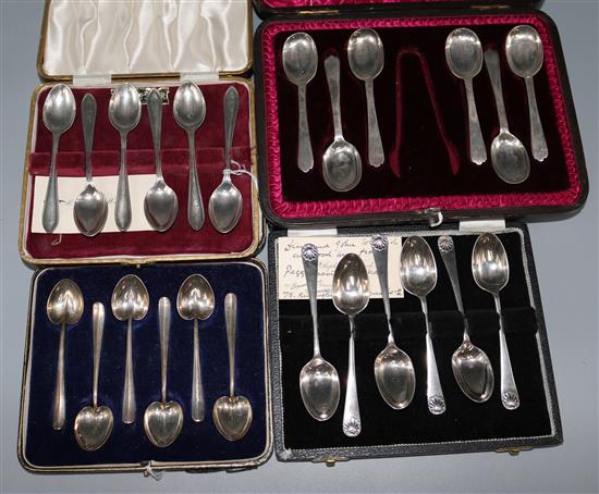 Four cased sets of six silver teaspoons.